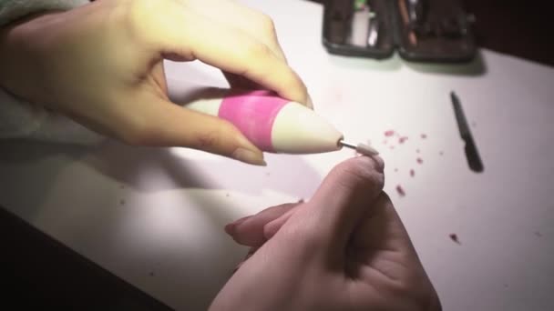 Chica en casa elimina el esmalte de uñas con una máquina especial para prepararse para una manicura. Primer plano — Vídeos de Stock