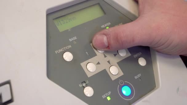 Работник выполняет работы на промышленном оборудовании, нажимая кнопки управления. close up — стоковое видео