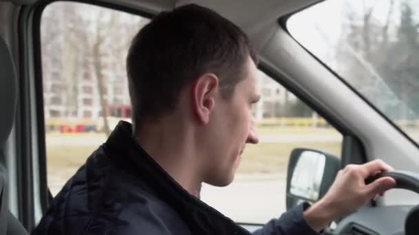 Young Man Talks Passenger While Driving Car City Street Using — Stock Video