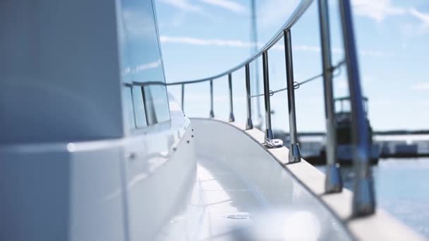 Yacht Moored In The Bay. View of yacht rails in focus with blur of Laser yachts behind. Follow the focus. — Stock Video