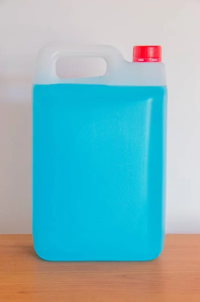 Bottle of blue antifreeze windshield washer fluid.