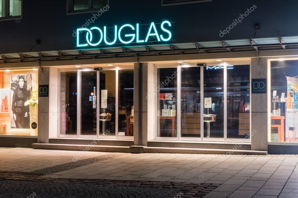 Bregenz, Austria - May 31, 2019: Entrance to Douglas at night. Douglas is an internationally operating perfumery chain.