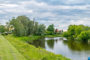 Lomza 'da bulutlu bir günde Narew nehrinde bulvarlar.