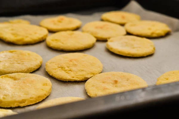 Cooked flat cakes from potato dough on baking paper on iron sheet