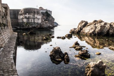 Taş duvarlar sakin su yansıtan ünlü tarihi kent ile Dubrovnik Hırvatistan Adriyatik Denizi kapalı küçük bir koy manzara fotoğrafı güçlendirilmiş.