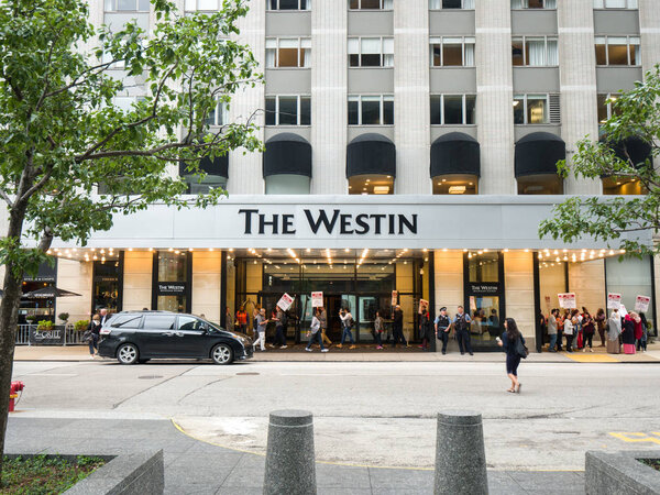 Chicago, IL - September 7th, 2018: Hotel workers across Chicago go on strike and march along the streets armed with signs and chanting in protest as they fight for better benefits and wages.