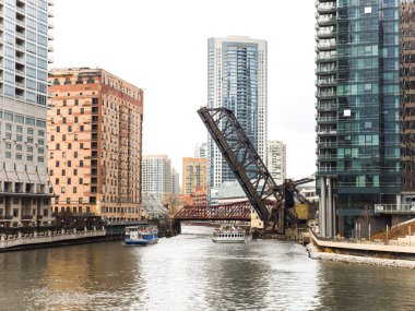 Chicago, IL - April 9th 2017:  The historic Chicago and North Western Railway's Kinzie Street railroad bridge stands raised over the river as an iconic structure to visitors and locals. clipart