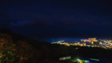 Ocho Rios'ta geceleri binalardaki ışıklar ile o koya bakan ve karanlık gelirken Jamaika tropik adasında yakındaki barlar, kulüpler ve gece hayatı yanıp sönen bir panning timelapse.