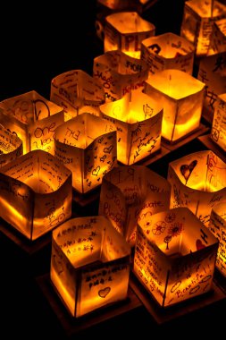 Chicago, Il - 20 Temmuz 2019: Lincoln Park'taki Water Lantern Festivali'nde Cumartesi akşamı müzik, yemek ve aile dostu etkinliklerle parlayan turuncu fenerler Güney Lagünü boyunca süzülüyor.