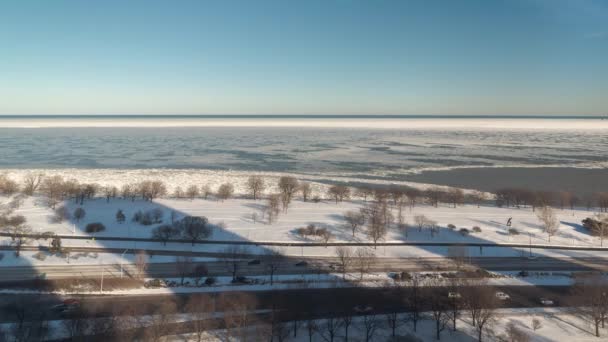 シカゴ 2019年1月21日 ミシガン湖の水の上に雪と氷が流れ込み 海岸沿いの交通動物園太陽が沈むと寒い冬の夜に運転する — ストック動画