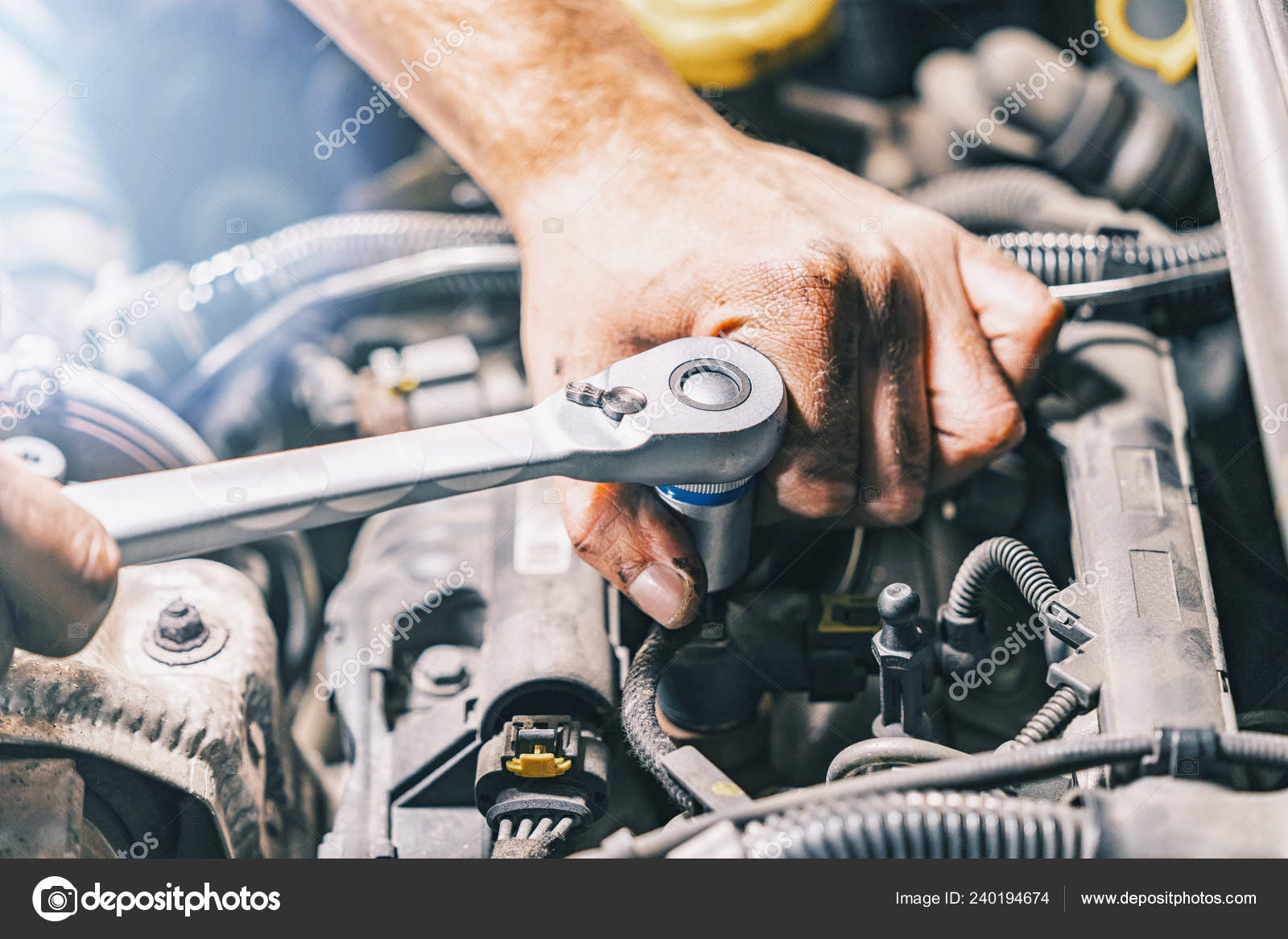 Hands of male car mechanic selecting wrench from tool box in repair garage  stock photo