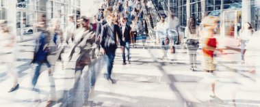 Kalabalık kalabalık şehir caddesinde yürüyor.