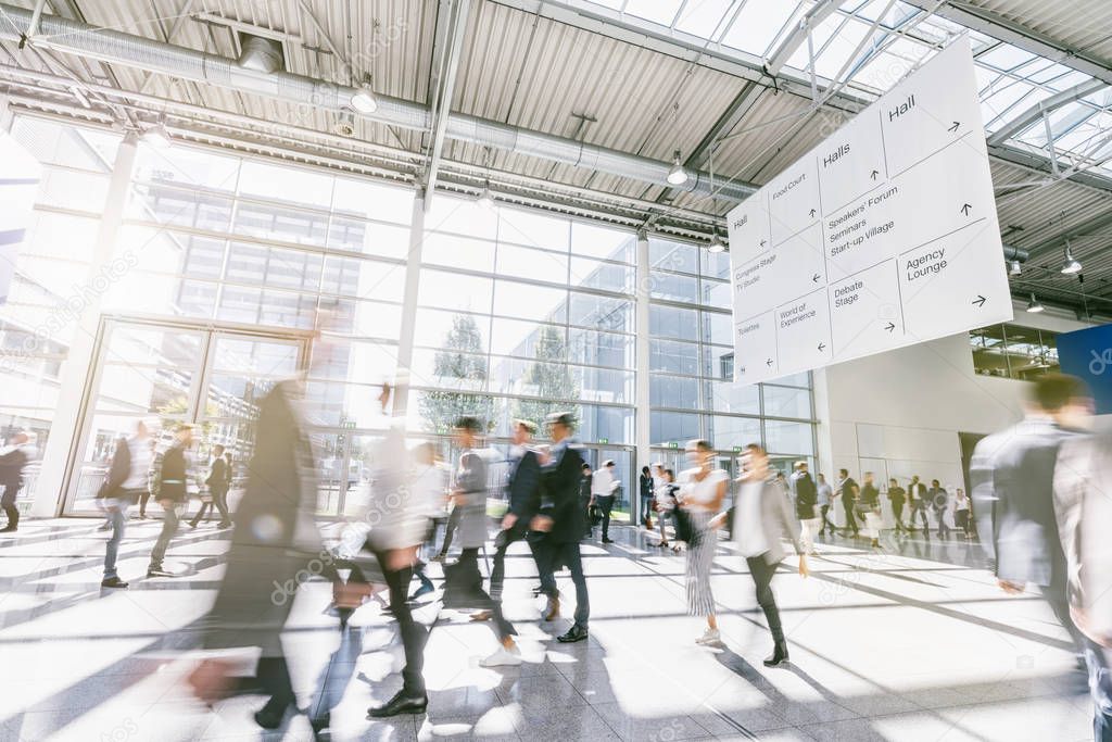 blurred business people at a trade fair