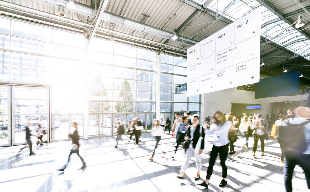 crowd of anonymous blurred business people at a tradeshow