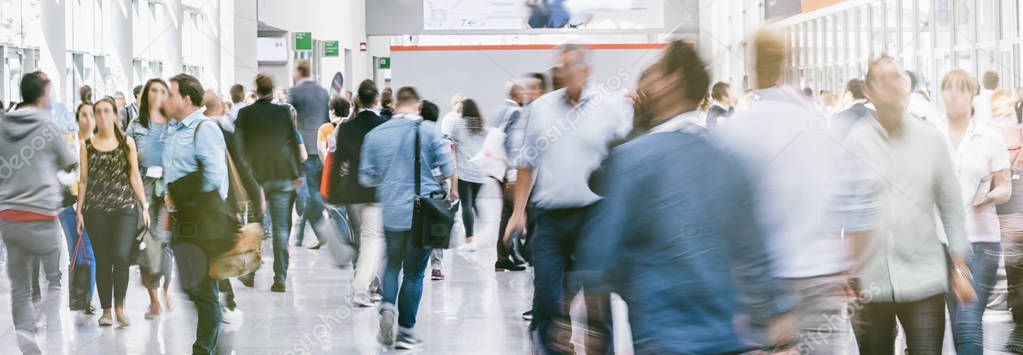 Large crowd of business people walking at a trade fair