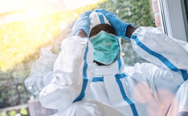 Exhausted clinician in intensive care unit in coronavirus pandemic