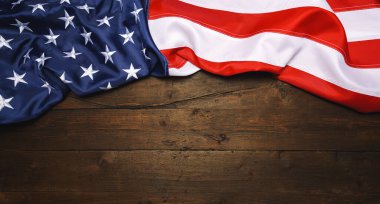 USA flagon placed on old grunge wooden planks. Motive of celebration, copyspace for your individual text.