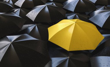Different, unique and standing out of the crowd yellow umbrella with rain drops