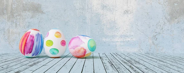 Painted easter eggs for Easter in front of a blue grunge background wall, including copy space, banner size