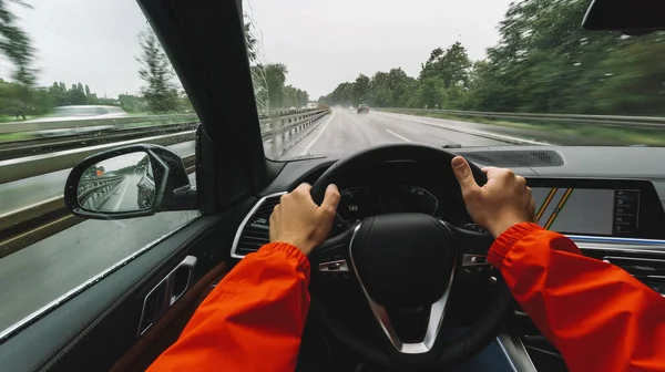 Driving car at a rainy day on a highway - POV, first person view shot