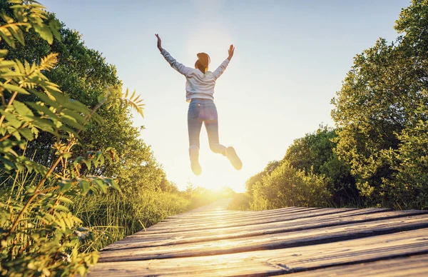 Happy Woman Jumping Raised Hands Legs Enjoying Life Wooden Path — Stock Photo, Image