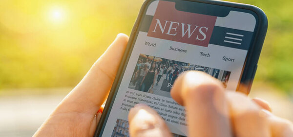 Online news on mobile phone. Close up of smartphone screen. Woman reading articles in application. Hand holding smart device. Mockup website. Newspaper and portal on internet.