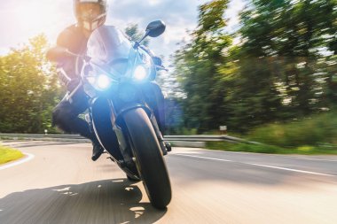 Motosiklet sürerken. Motosiklet turunda boş bir yolda araba sürerken eğleniyorum. bireysel metniniz için kopyalama alanı.