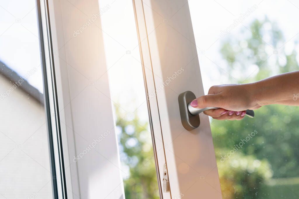 hand open white plastic pvc window at home