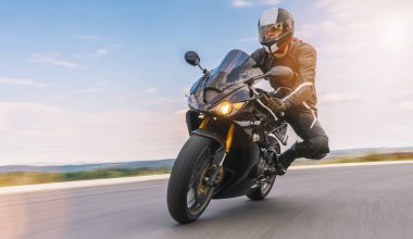 Virajlı yolda motosiklet sürmek. Motosiklet gezisinde boş yolda araba kullanmak. bireysel metniniz için kopyalama alanı.