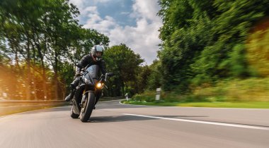 Yazın motosiklet sürerken. Motosiklet turunda boş yolda araba kullanmak. bireysel metniniz için kopyalama alanı.