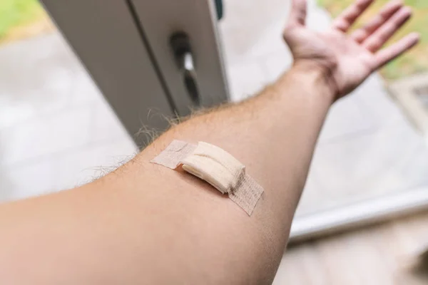 Human arm after Vaccination with adhesive plaster