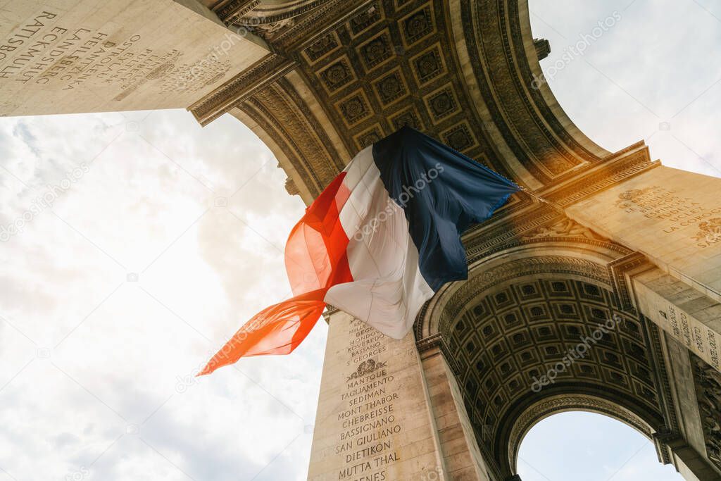Arc de Triomphe with french flag during bastille day in paris, france