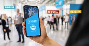 coronavirus tracking app on a mobile smartphone. Close up of woman tracking crowd of people in a smartphone screen application. Hand holding smart device. Mockup website. covid-19 corona virus tracker