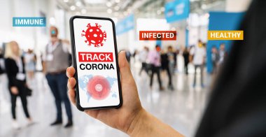 coronavirus tracker app on a mobile smartphone. Close up of woman tracking crowd of people in a smartphone screen application. Hand holding smart device. Mockup website. covid-19 corona virus tracker
