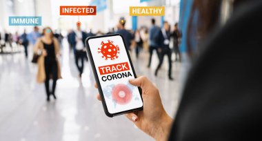 coronavirus tracker app on a mobile smartphone. Close up of woman tracking crowd of people in a smartphone screen application. Hand holding smart device. Mockup website. covid-19 corona virus tracker