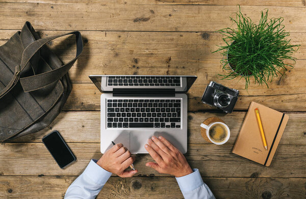 Top view of Businessman using Laptop in Office