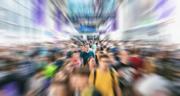 Zoom on anonymous crowd at a trade show or in a trade mall