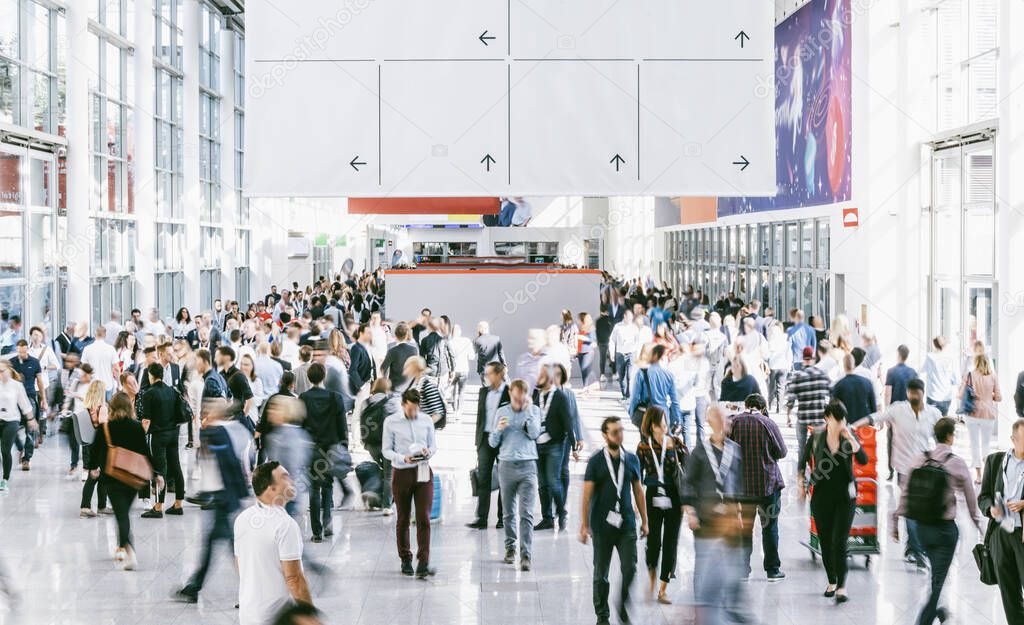 Crowd of people walking on a trade show in london