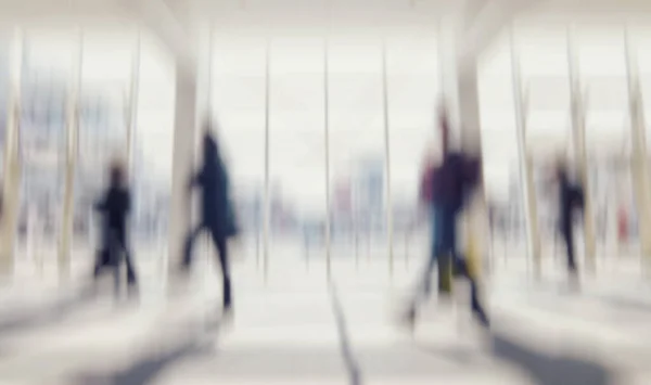 Intentionally blurred commuters walking in a floor background
