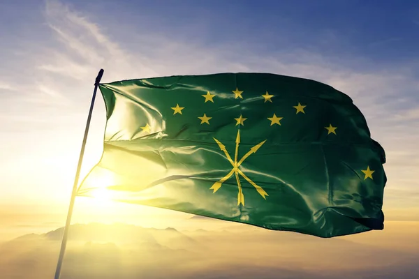 Adygea Republic of Russia flag textile cloth fabric waving on the top sunrise mist fog — Stock Image Adygea Republic Russia Flag Textile Cloth Fabric Waving Top Sunrise Royalty Free Stock Photos