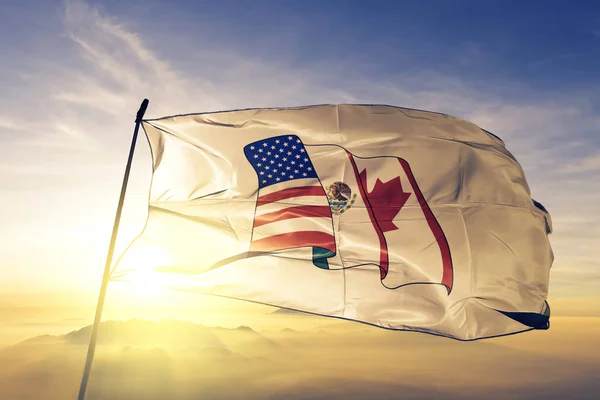 North American Free Trade Agreement NAFTA flag textile cloth fabric waving on the top sunrise mist fog