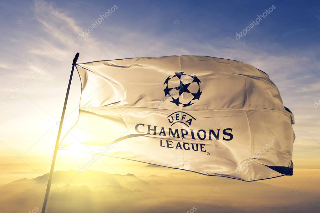 UEFA Champions League logo flag textile cloth fabric waving on the top sunrise mist fog
