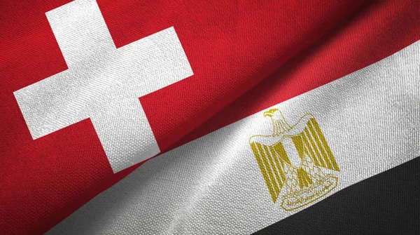 Switzerland and Egypt flags together relations textile cloth, fabric texture. Text on egyptian flag means - Arab Republic of Egypt