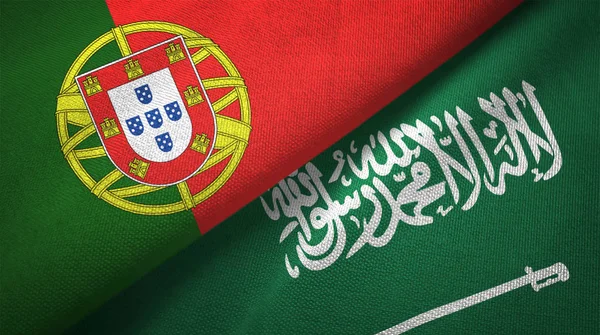 Portugal and Saudi Arabia flags textile cloth, fabric texture. Text on saudi arabian flag means - There is no god but God, Muhammad is the Messenger of God
