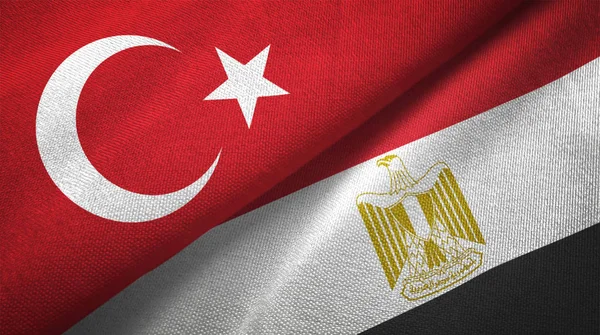 Turkey and Egypt flags together textile cloth, fabric texture. Text on egyptian flag means - Arab Republic of Egypt