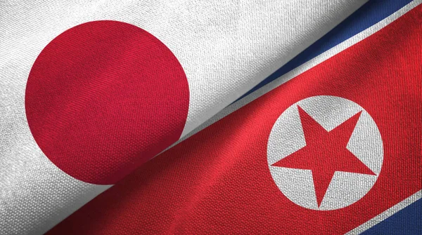 Japan Noord Korea Twee Gevouwen Vlaggen Samen — Stockfoto