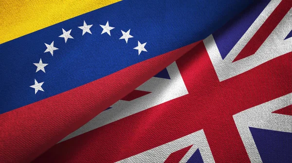 Venezuela y Reino Unido dos banderas tela textil, textura de la tela —  Fotos de Stock