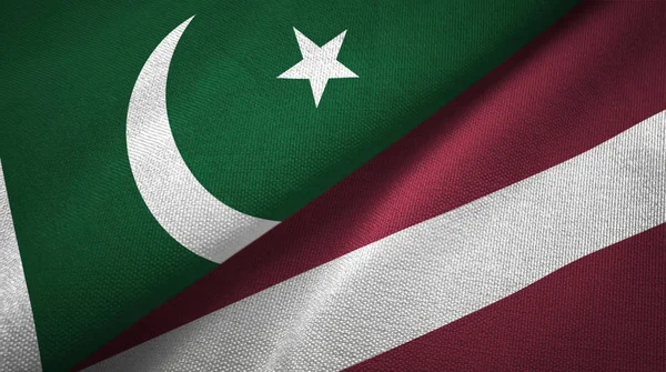 Pákistán a Lotyšsko dvě vlajky textilní tkaniny, textura textilií — Stock fotografie