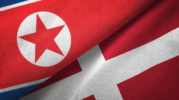 Noord-Korea en Denemarken twee vlaggen textieldoek, weefsel textuur — Stockfoto