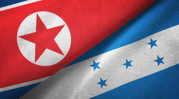 Noord-Korea en Honduras twee vlaggen textieldoek, weefsel textuur — Stockfoto